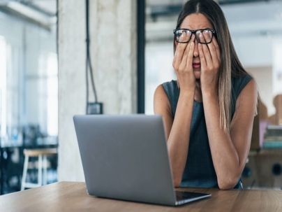 a worried woman working on a laptop